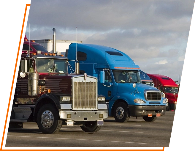 A group of trucks parked in a parking lot.