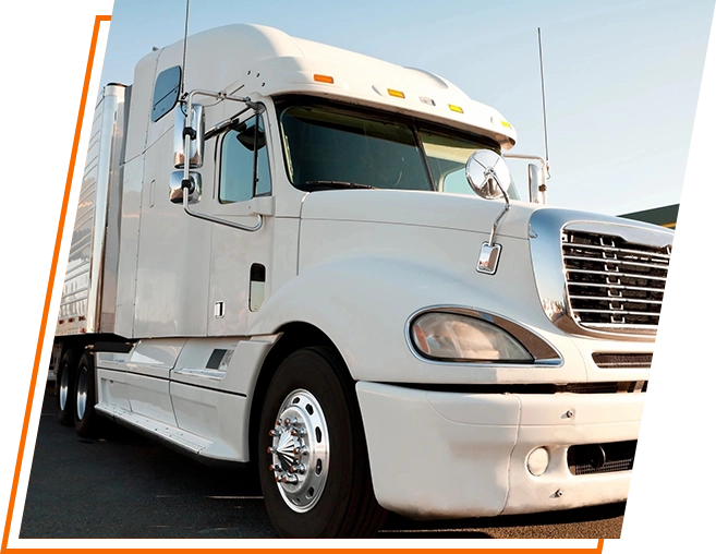 A white truck is parked on the side of the road.