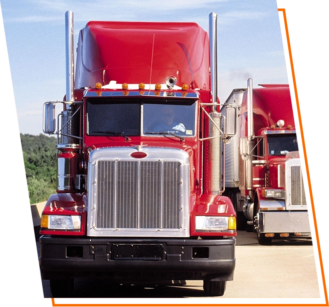 A red truck is parked on the side of the road.